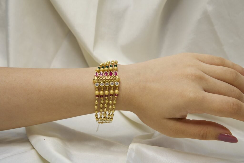 Traditional Gold-Plated Multi-Strand Bracelet with Ruby, Emerald, and Pearl Embellishments