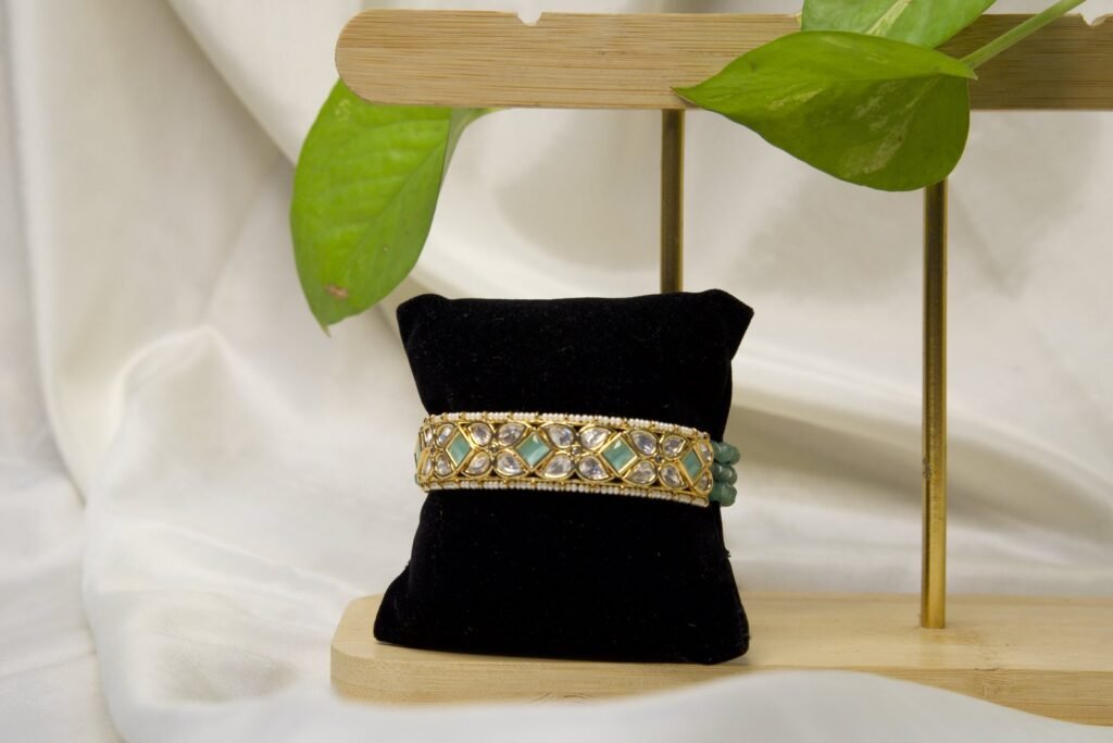 Traditional Gold-Tone Bangle with Green Stone Embellishments