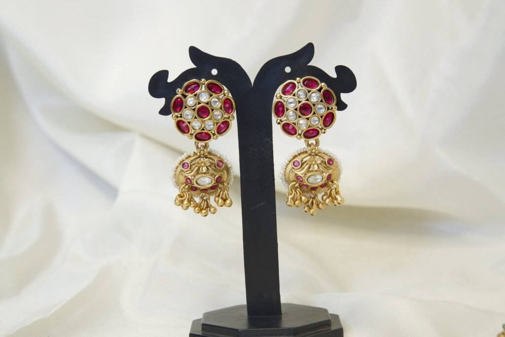 Traditional Gold-Tone Jhumka Earrings with Red Stone Studs