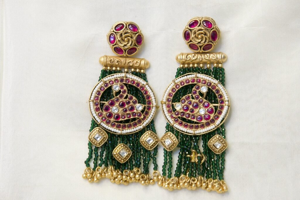 Traditional Kundan and Bead Tassel Earrings with Green Beads and Pink Gemstone Design