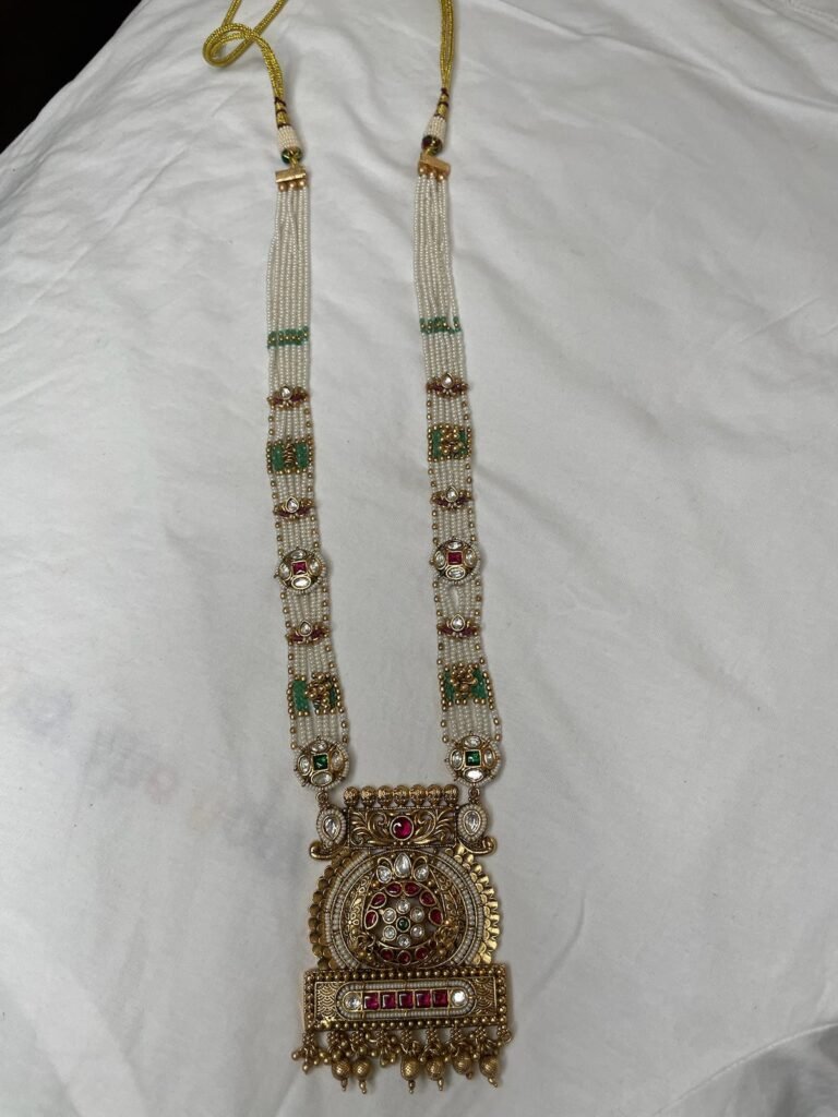 Traditional Pearl Mala Necklace Set with Jhumka Earrings - Antique Gold Finish with Red & Green Stones