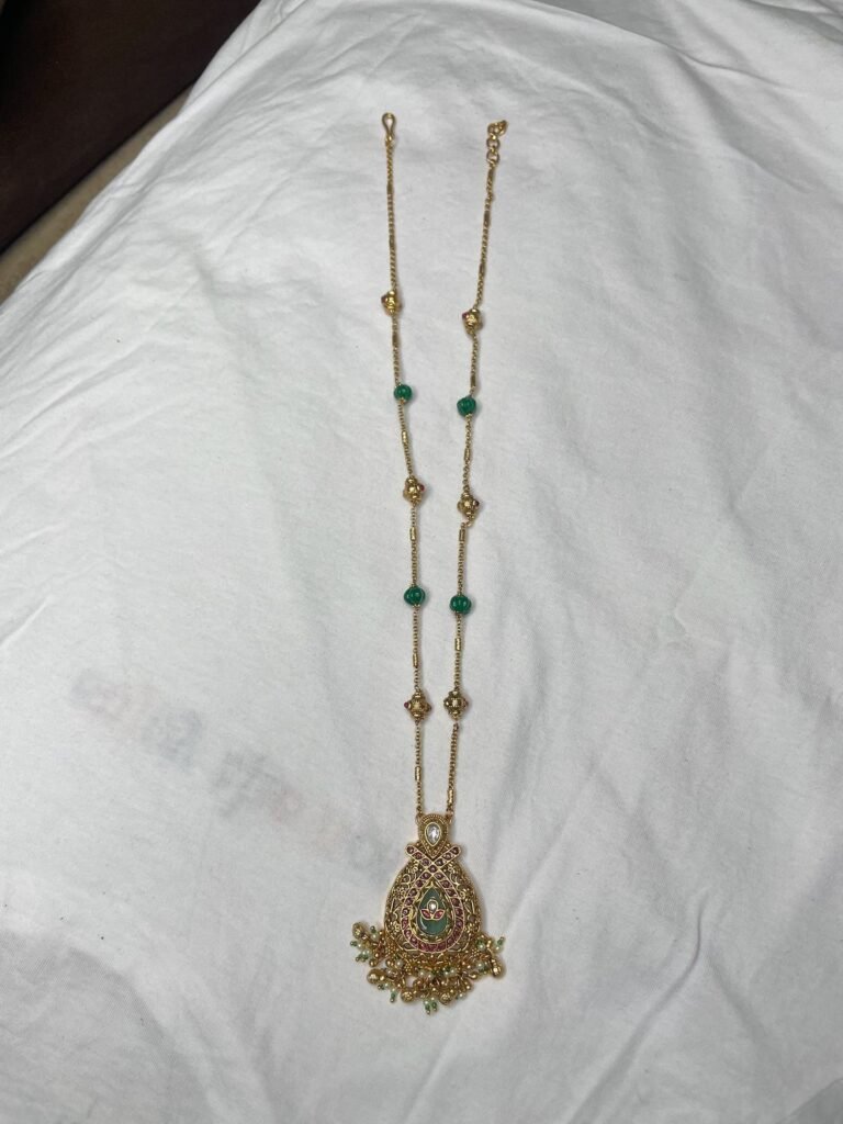 Golden Kundan Necklace Set with Green Beads and Matching Earrings